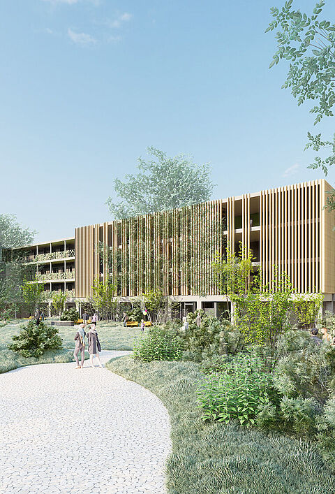 Moderne Wohnanlage mit begrünten Wegen und Fassaden, umgeben von Bäumen und Sträuchern.